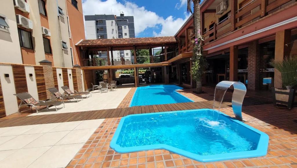 a swimming pool in the middle of a building at Pousada Sonho Meu Foz in Foz do Iguaçu