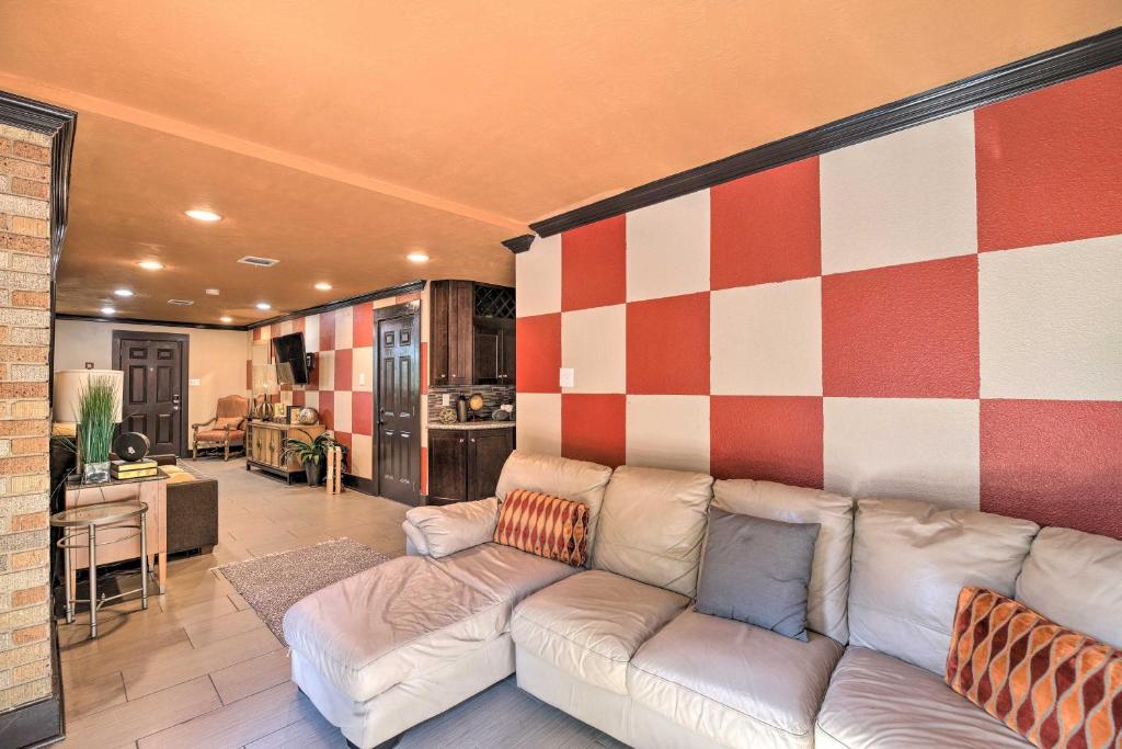a living room with a couch and a checkered wall at Eclectic Houston Home Less Than 4 Mi to Downtown! in Houston