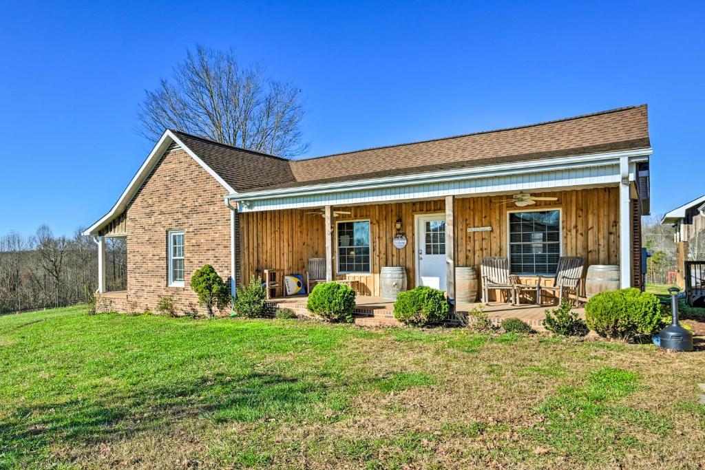 a house with a porch with chairs on a yard at Breathtaking Elkin Getaway with Vineyard Views! in Elkin