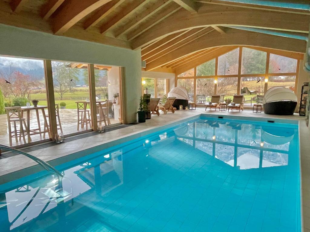 a large swimming pool in a house at Boutique Hotel Längenfelder Hof in Grainau