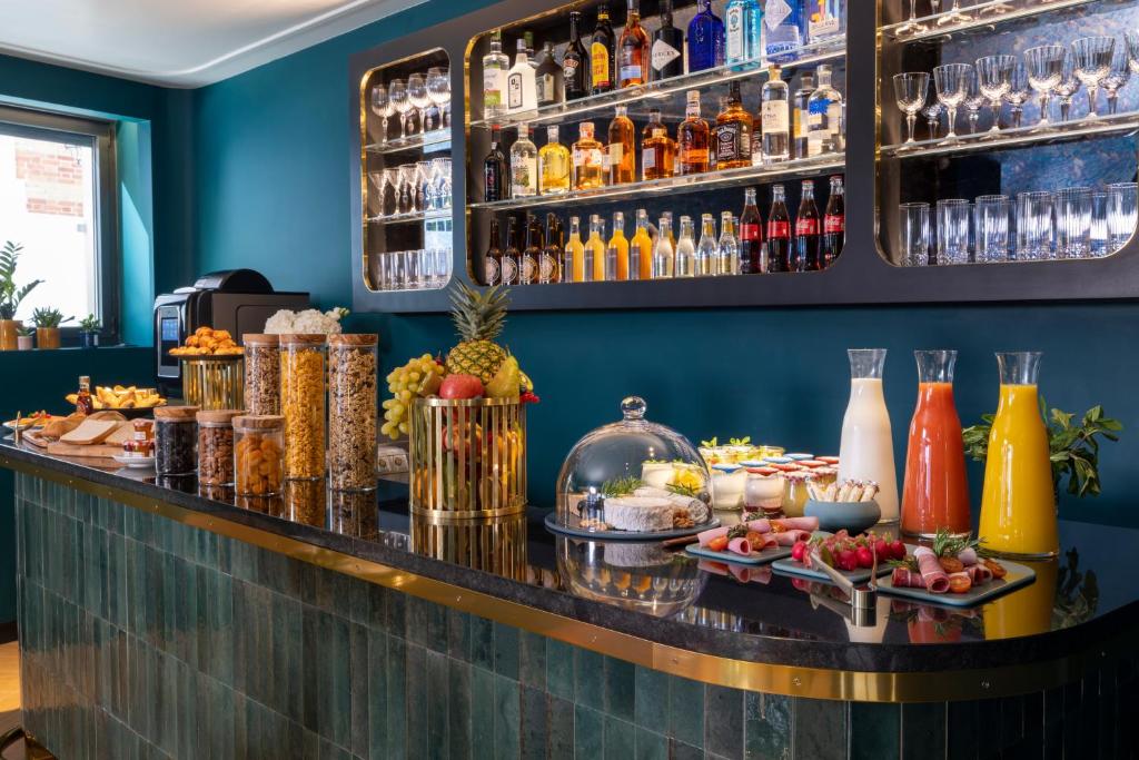 a bar with a buffet of food and drinks at Hôtel Toujours &amp; Spa in Paris