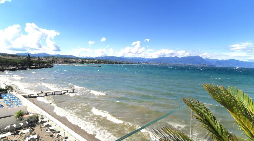 a view of a beach and the ocean at TRA CIELO E LAGO - Gerale H&B (CIR017067-CIM-00420) in Desenzano del Garda