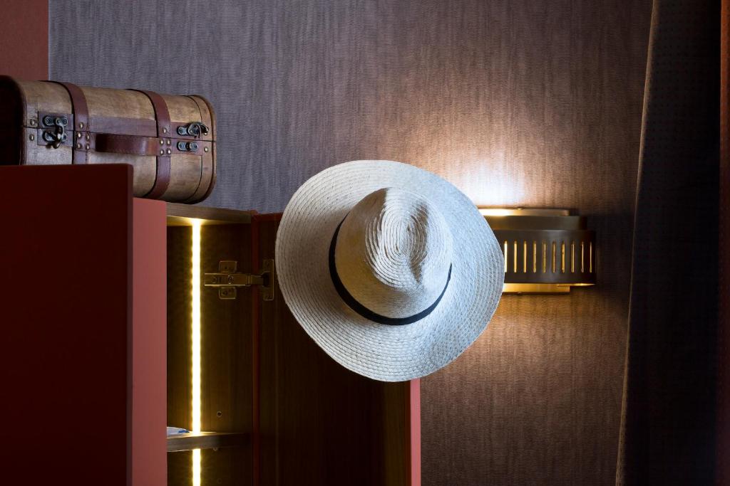 a straw hat is hanging on a door at Hotel Whistler - Gare du Nord in Paris