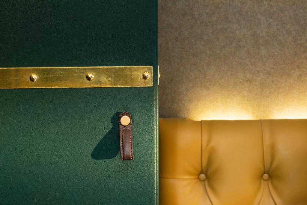 a door with a key on it next to a couch at Hotel Whistler - Gare du Nord in Paris