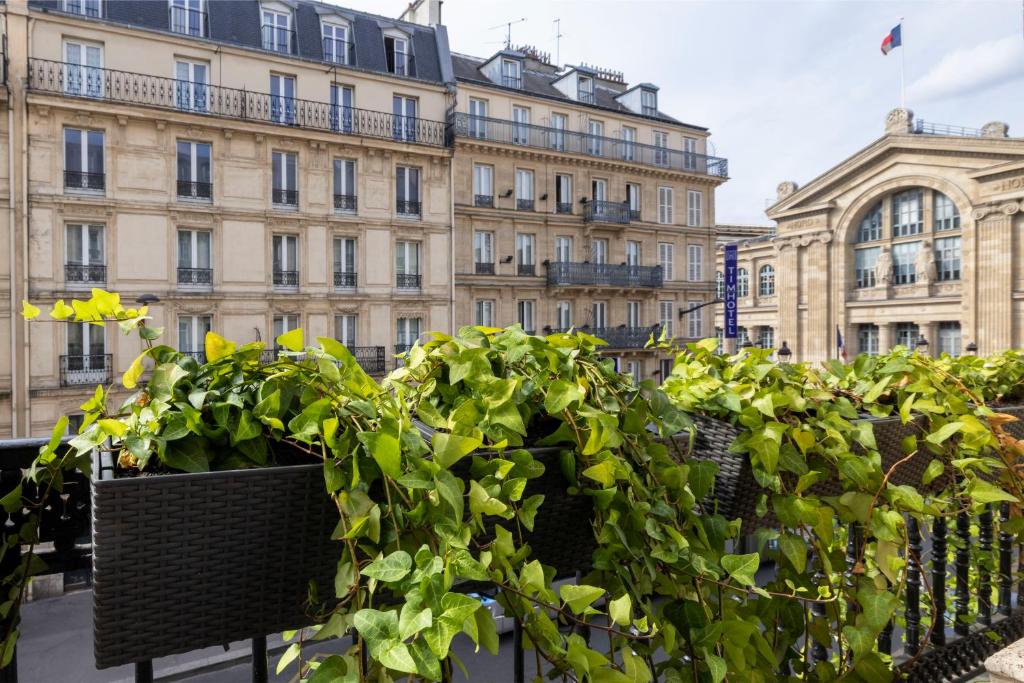 a row of potted plants in front of a building at Hotel Whistler - Gare du Nord in Paris