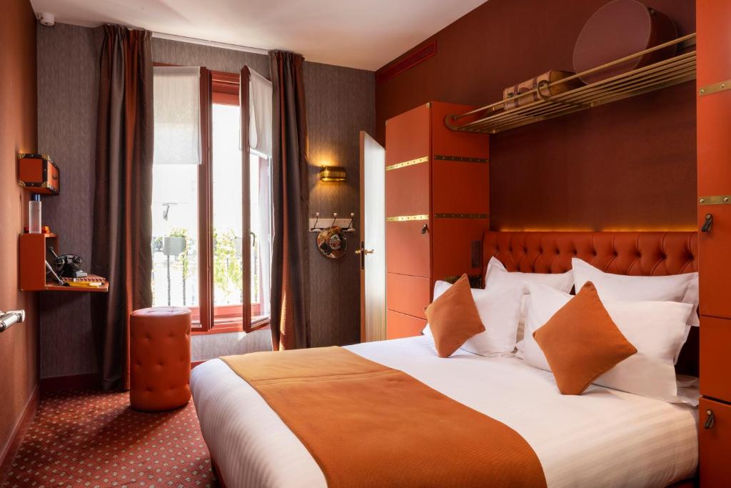 a bedroom with a large bed and a window at Hotel Whistler - Gare du Nord in Paris