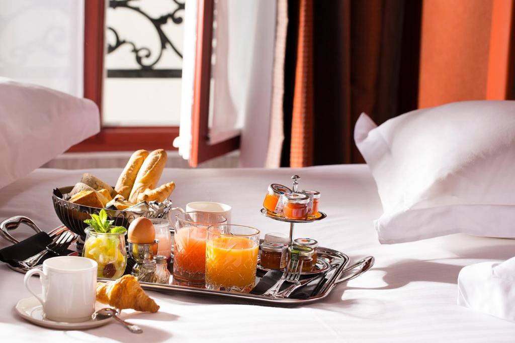 a tray of drinks and bread on a table at Hotel Whistler - Gare du Nord in Paris