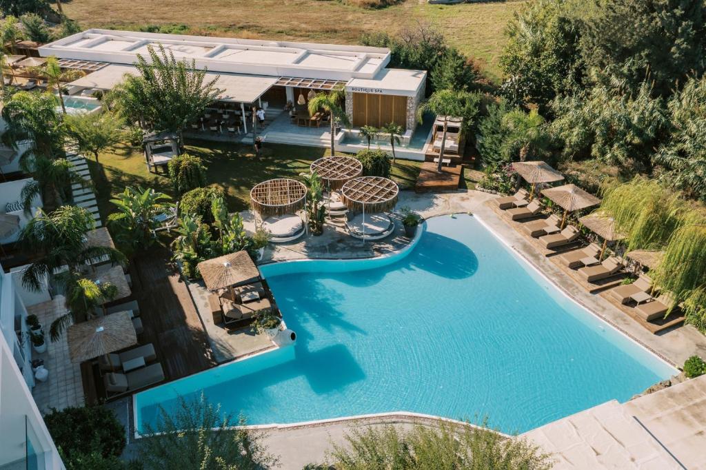 an aerial view of a swimming pool with a resort at Kouros Exclusive Hotel & Suites - Adults Only in Faliraki