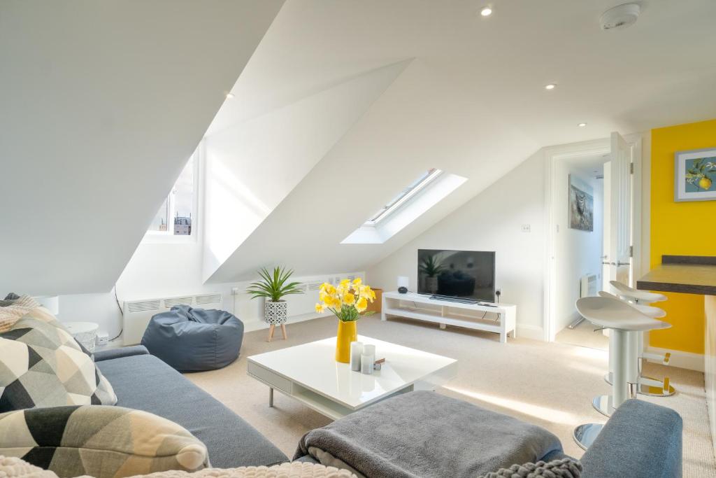 a living room with a couch and a table at Stylish Herne Bay apartment by the sea in Kent