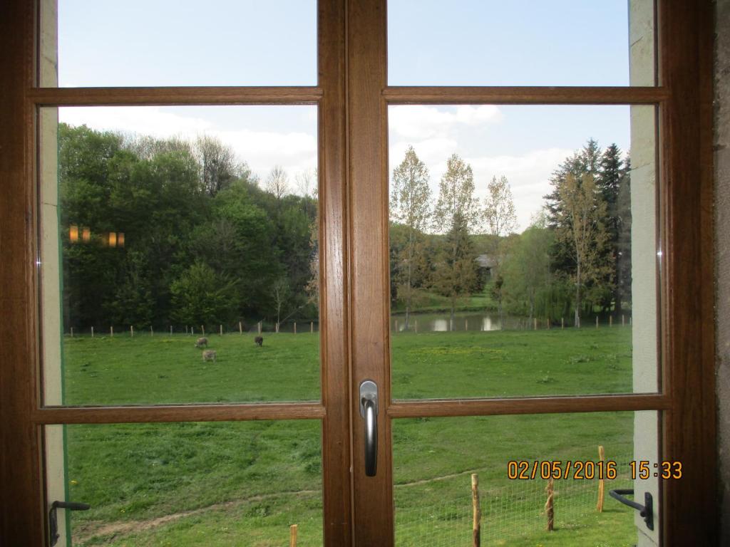 a view of a field through a window at Appartement La petite Résie in La Résie-Saint-Martin