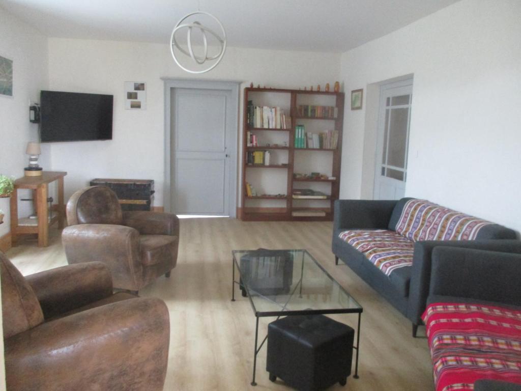 a living room with a couch and chairs and a table at Appartement La petite Résie in La Résie-Saint-Martin