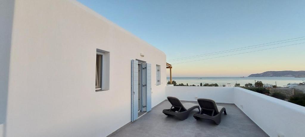 2 Stühle auf einem Balkon mit Meerblick in der Unterkunft Casa Di Kimolos in Kimolos