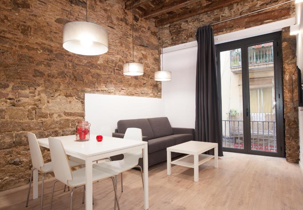 a living room with a table and a couch at Habitat Apartments Alissia in Barcelona
