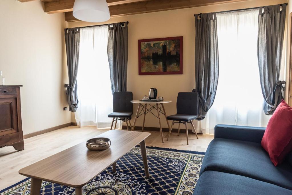 a living room with a blue couch and a table at Casa Collini Salò in Salò