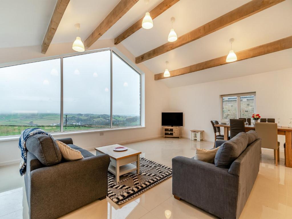 a living room with two chairs and a large window at Hen House View 2 - Uk41551 in Crawshaw Booth