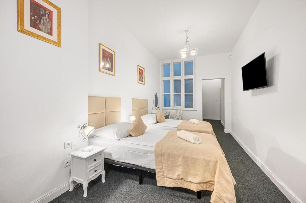 A bed or beds in a room at Downtown Bratislava B&B