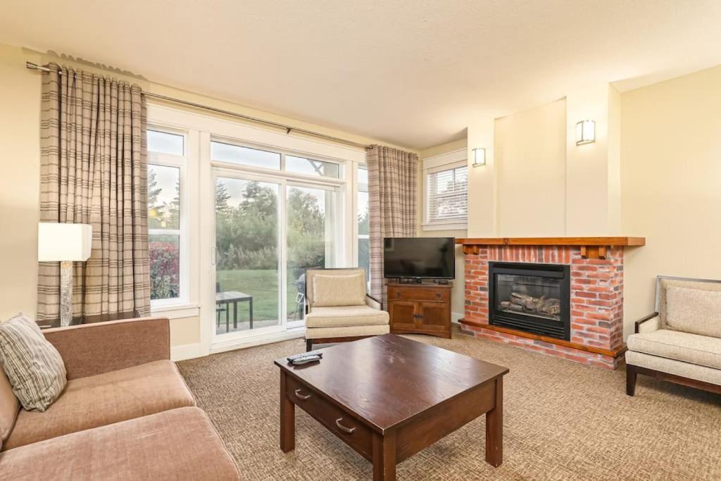 a living room with a couch and a fireplace at Blue Mountain Retreat at Rivergrass in Blue Mountains