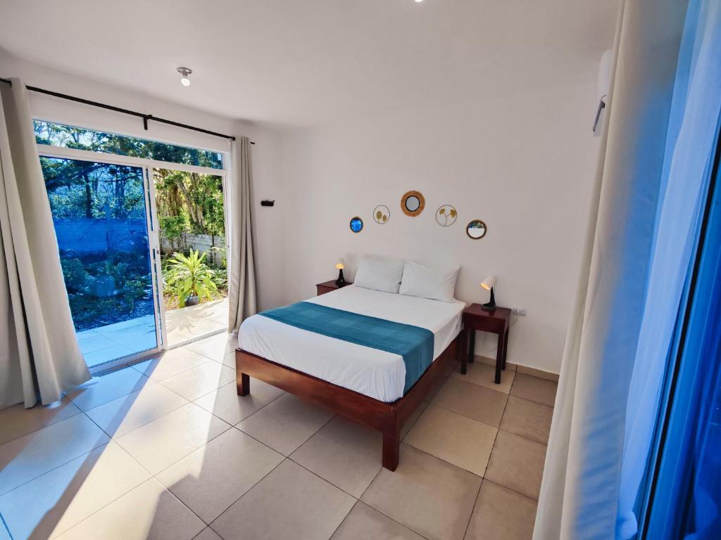 a bedroom with a bed and a large window at VIVE El VALLE Hotel in El Valle