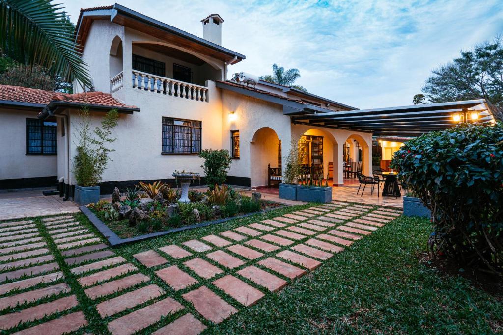 a house with a garden in front of it at Cozy Stead in Nairobi