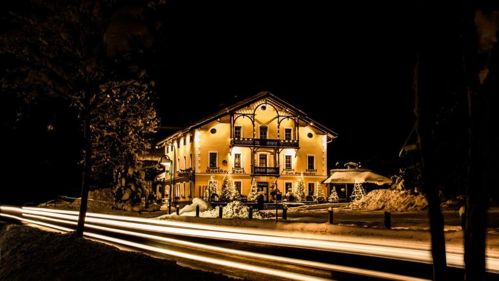 a house with a light trails in front of it at night at Gasthof Post St. Martin am Tgb. in Sankt Martin am Tennengebirge