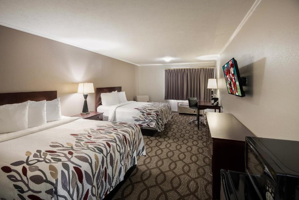 a hotel room with two beds and a television at Red Roof Inn & Suites Lexington - Hamburg in Lexington