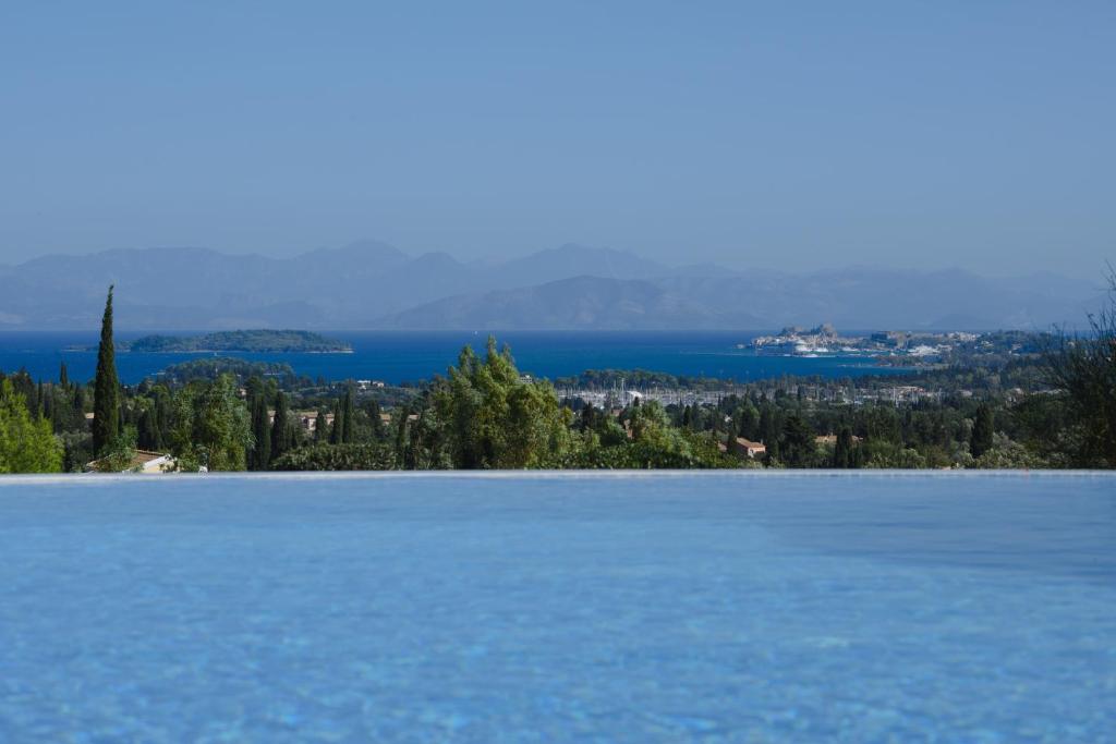 a view of a large blue lake with trees and water at Villa Verde in Pouládes