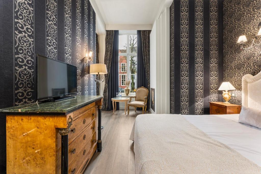 Postel nebo postele na pokoji v ubytování Canal Suites