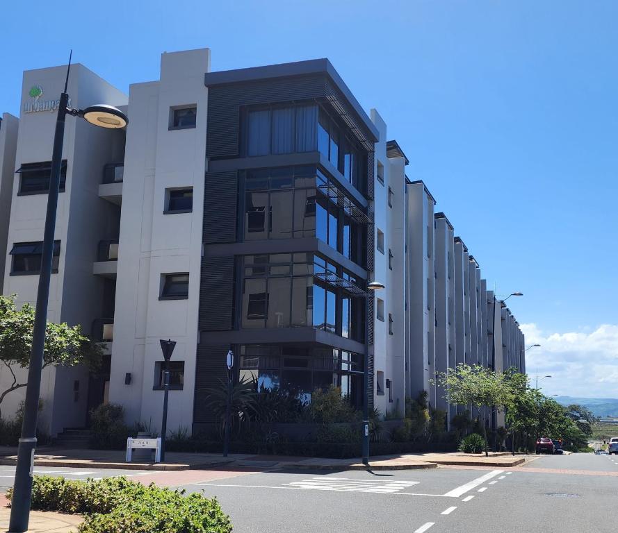 a tall building on a city street with a street light at Urban Park Apartment in Durban