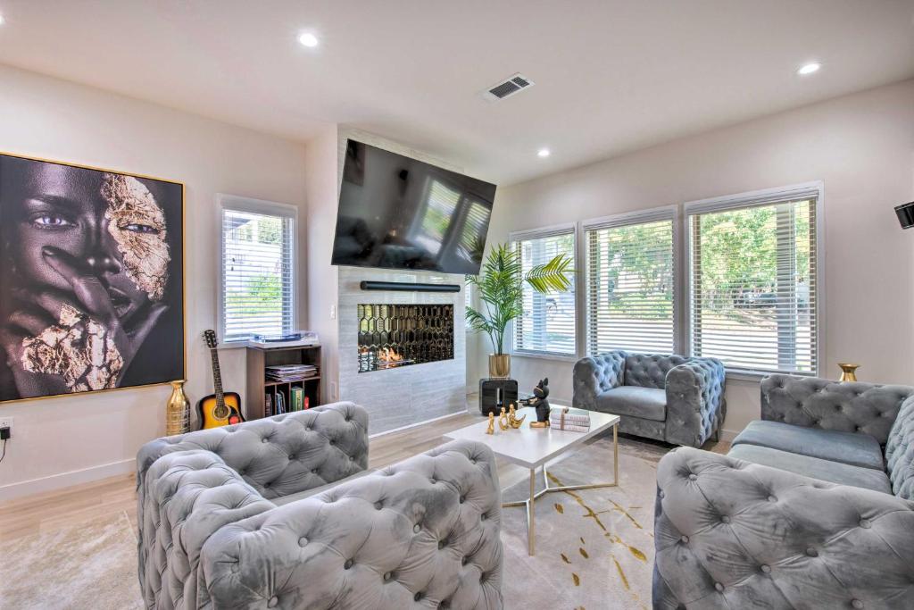 a living room with two couches and a fireplace at Luxury Smart Home 2 Miles to Downtown Atlanta! in Atlanta
