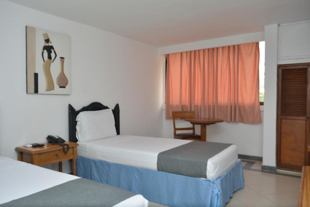 Postel nebo postele na pokoji v ubytování Hotel Casa Ballesteros