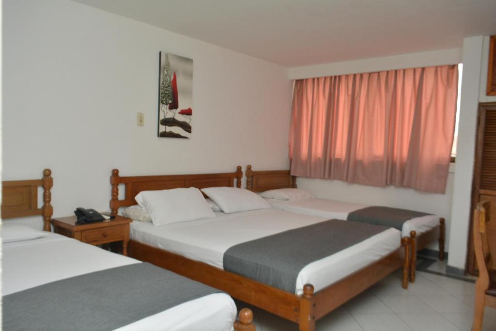 Postel nebo postele na pokoji v ubytování Hotel Casa Ballesteros