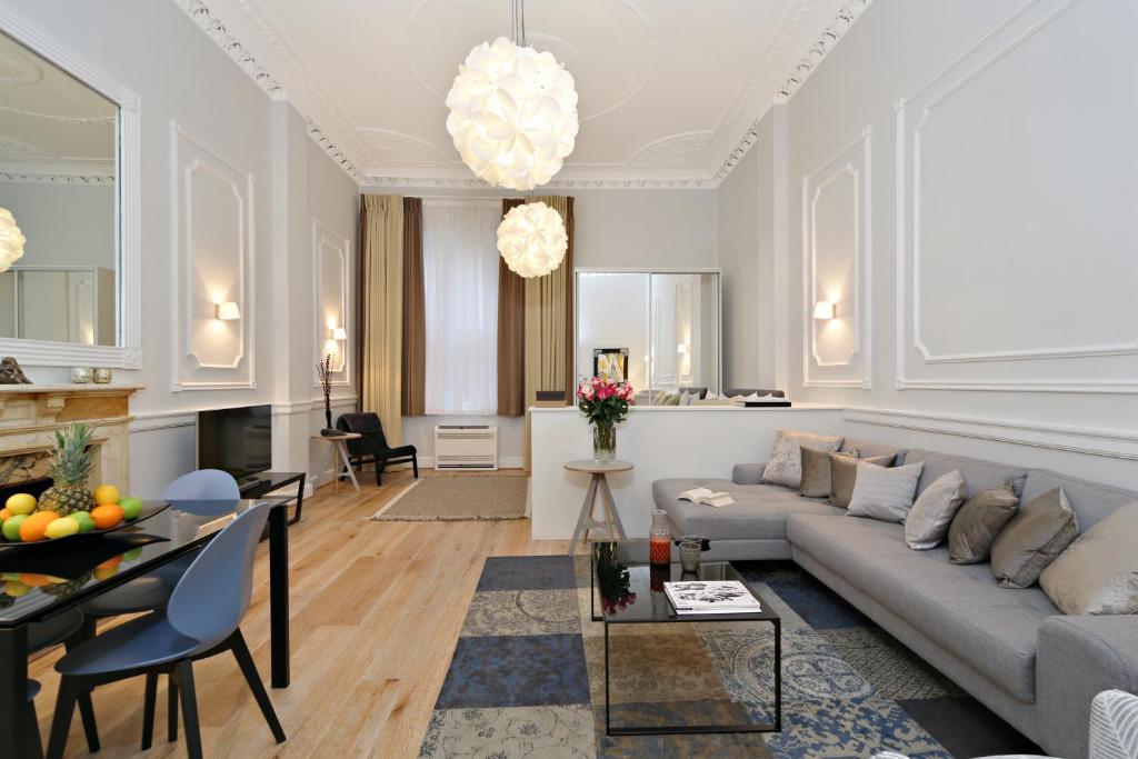 a living room with a couch and a table at Queensgate Court in London