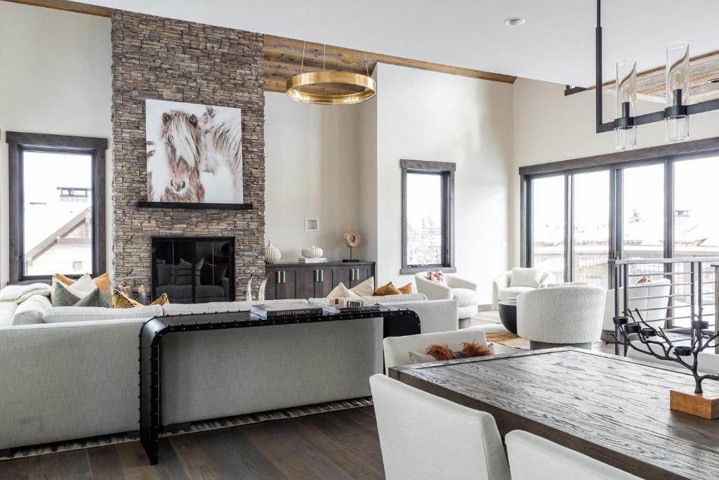 a living room with a couch and a fireplace at Spanish Peaks Highlands Cabin 18 in Big Sky