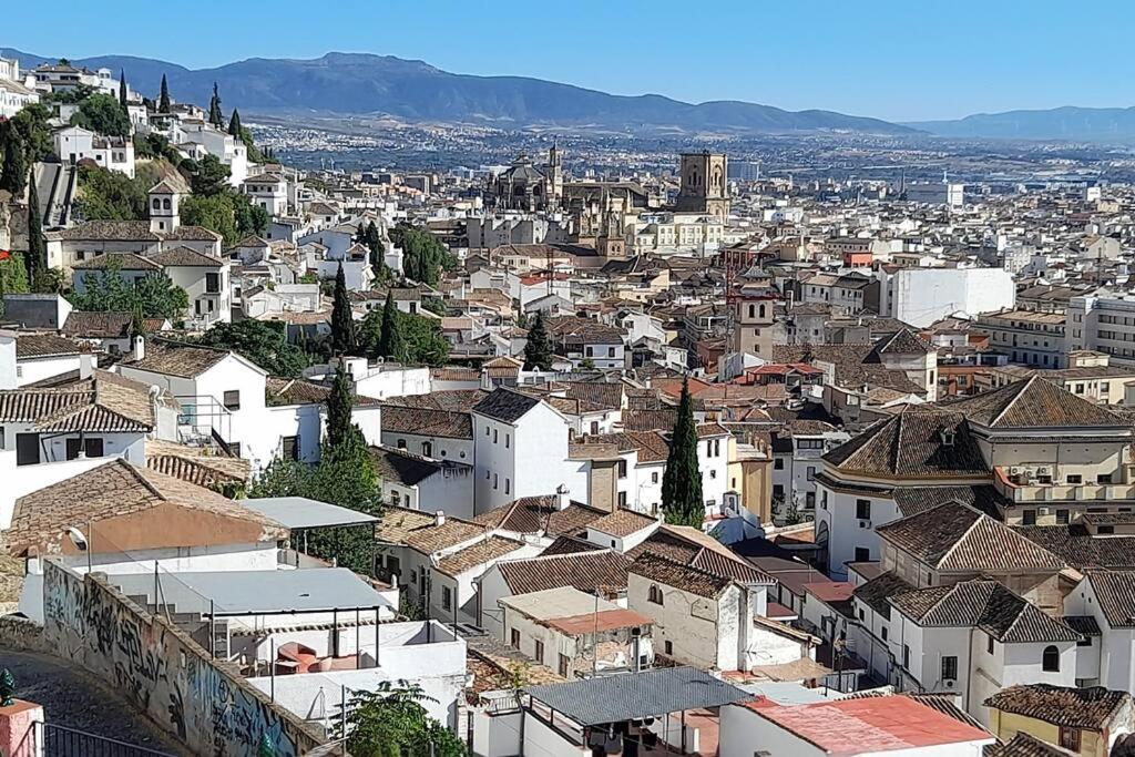 an aerial view of a city with houses and roofs at Apartamento con Vistas en Albaicin II in Granada