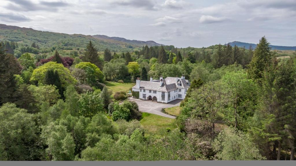 an aerial view of a house in the forest at MacFarlane Apartment in Taynuilt