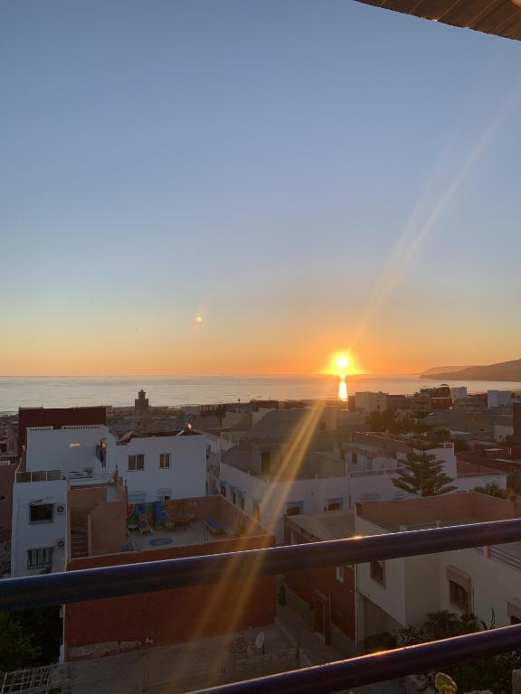 a view of the sunset from the balcony of a building at Agachill Surf House in Tamraght Ouzdar