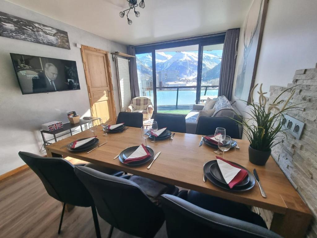 a dining room with a wooden table and chairs at Vanoise C in La Daille