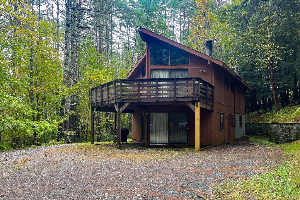 a house in the middle of a forest at Dwight Road Getaway in Quechee