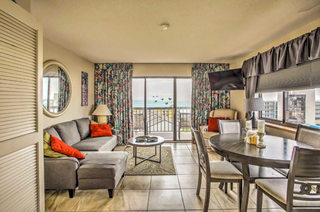 a living room with a couch and a table at Beach Access, Ocean View Myrtle Beach Condo! in Myrtle Beach