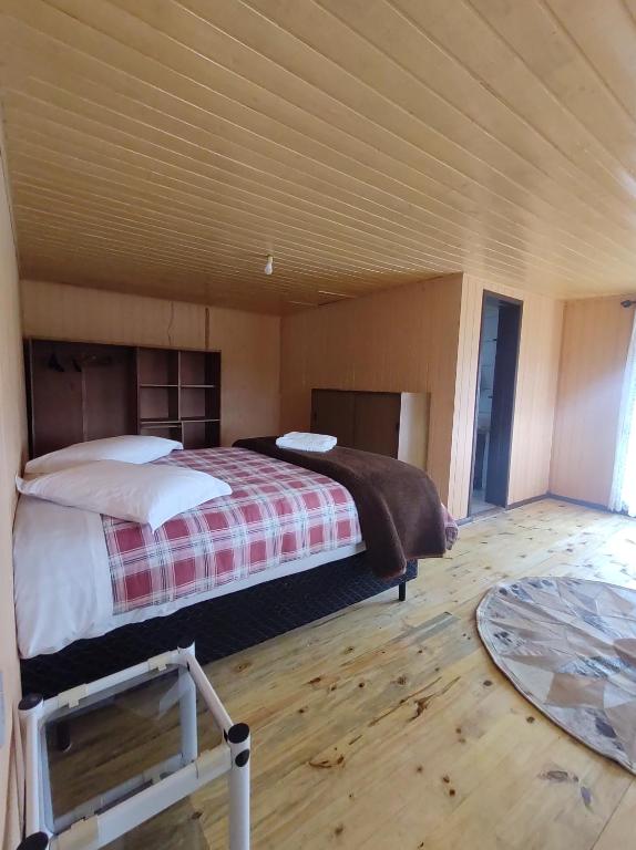 a bedroom with a large bed in a room at Pousada Rural Capão das Vertentes in Cambará