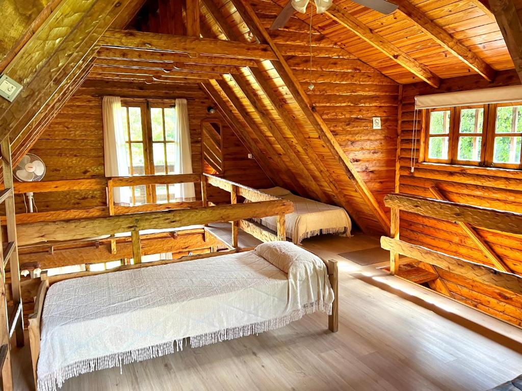 1 dormitorio con 2 camas en una cabaña de madera en Casa Estilo Cabaña, Bosque Peralta Ramos en Mar del Plata