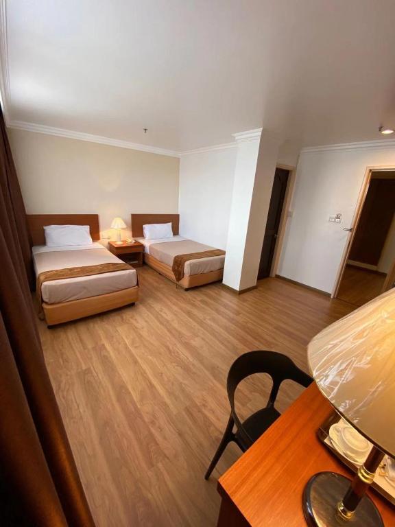 Postel nebo postele na pokoji v ubytování Kawan Hotel