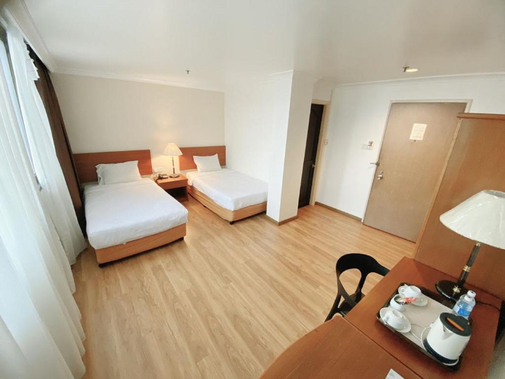 Postel nebo postele na pokoji v ubytování Kawan Hotel