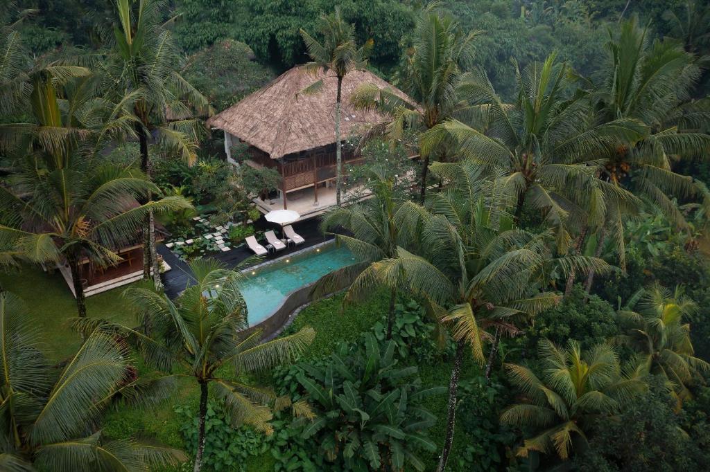 an aerial view of a resort with a pool and palm trees at Villa Inka Ubud by Nakula in Ubud