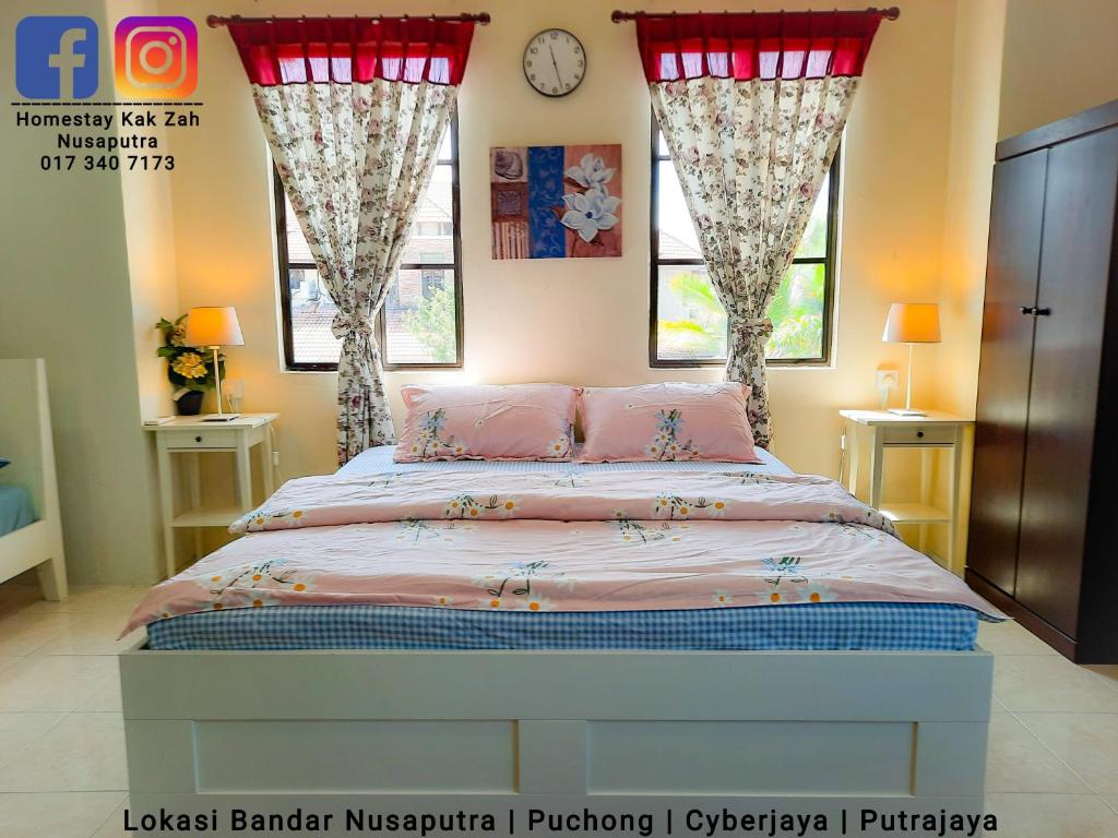 a bedroom with a bed with pink sheets and two windows at Homestay Kak Zah Nusaputra 4Room at Puchong Cyberjaya Putrajaya SplashMania in Puchong New Village