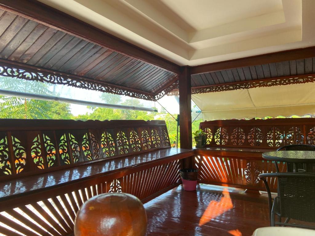 a balcony of a house with a wooden railing at Lampang Hideaway Guesthouse in Lampang