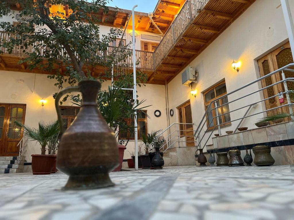 a vase sitting on a table in front of a building at Old Bukhara Boutique in Bukhara