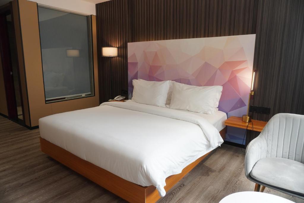 Postel nebo postele na pokoji v ubytování Joy Hotel