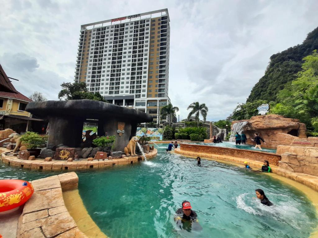 a pool at a theme park with people in the water at Sunway Onsen Studio @ Lost World of Tambun in Ipoh