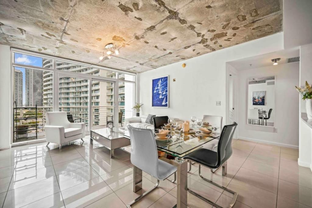a dining room with a table and chairs at Amazing 2 Bed in Midtown with FREE Parking in Miami